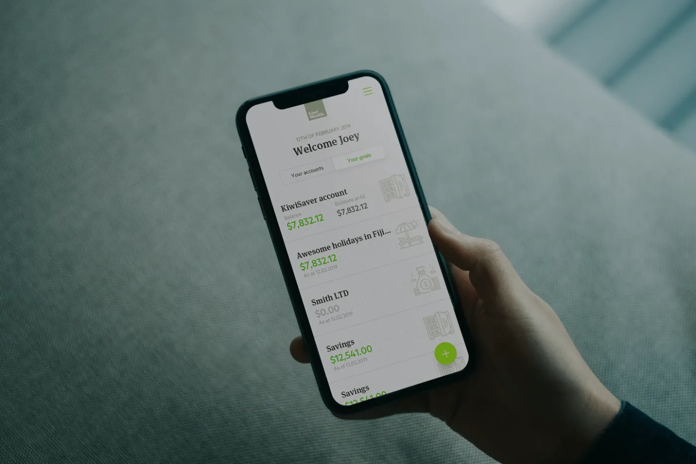 Kiwi Wealth app on a phone, showing savings goals