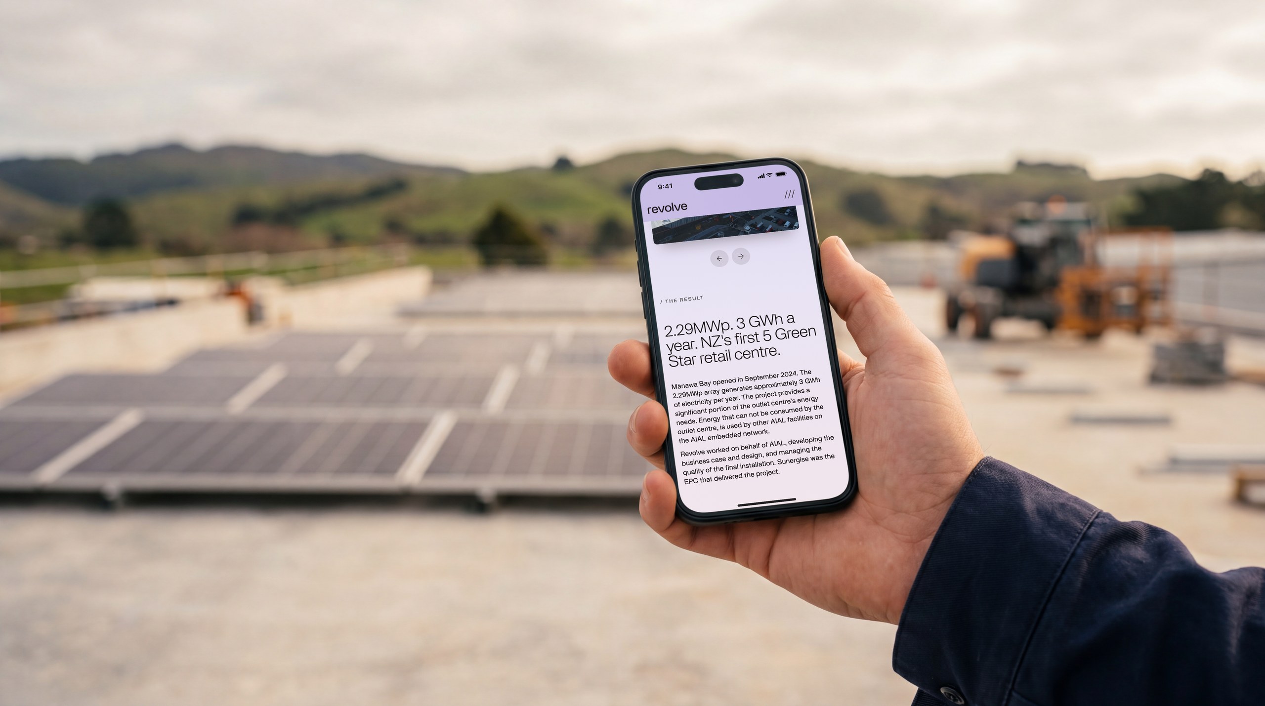 A Revolve Energy case study on a phone, on a solar rooftop