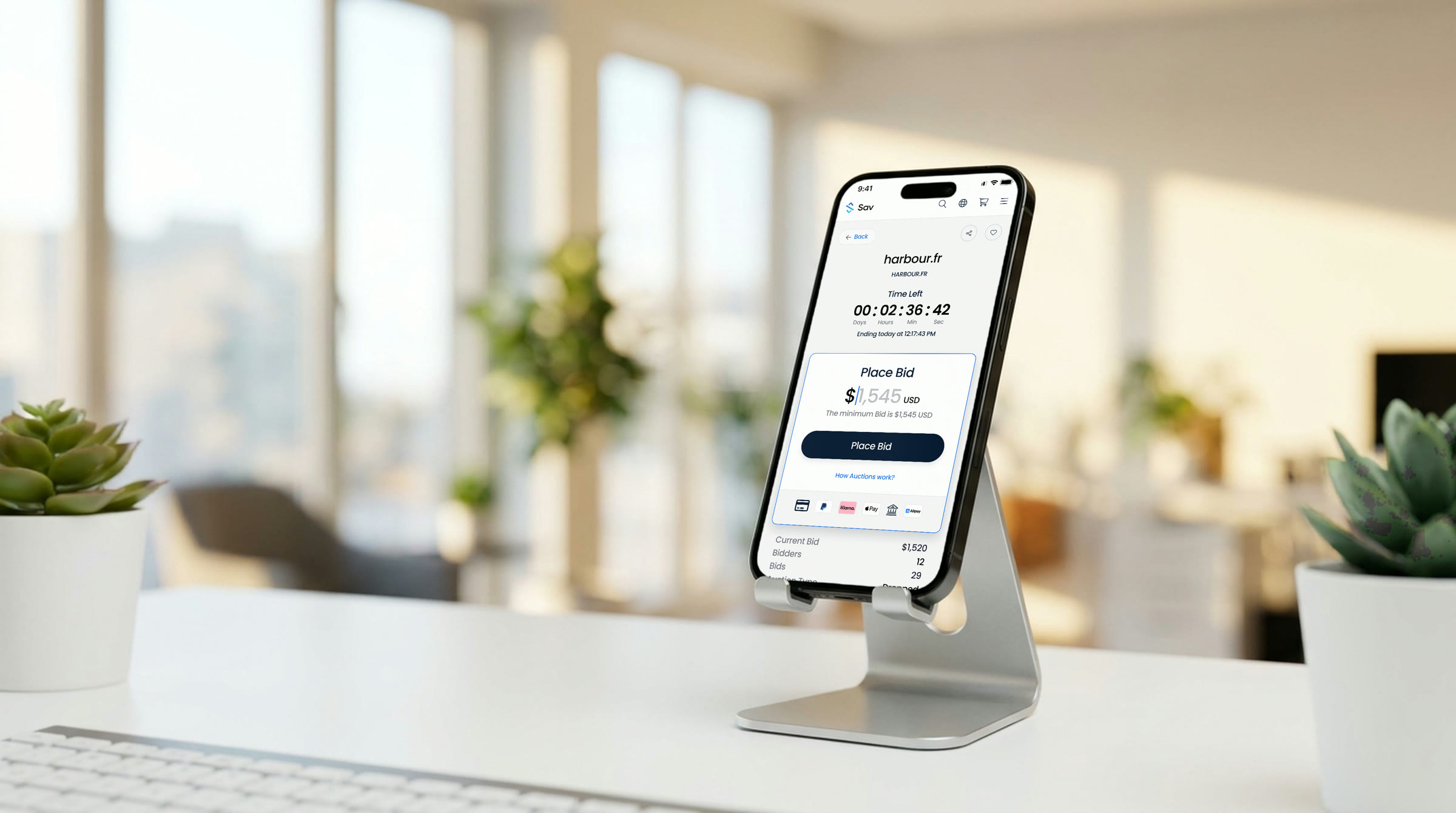 Sav's domain auction page on a phone in a stand, with the bid panel open
